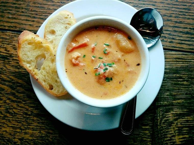 A creamy soup with toasted italian bread on the side