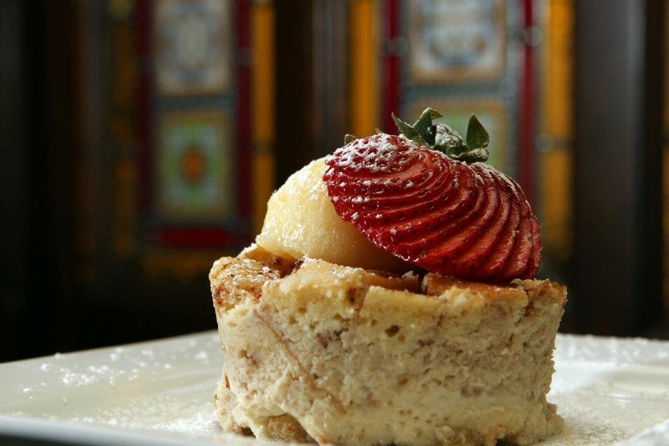 A cupcake dessert topped with sliced strawberries